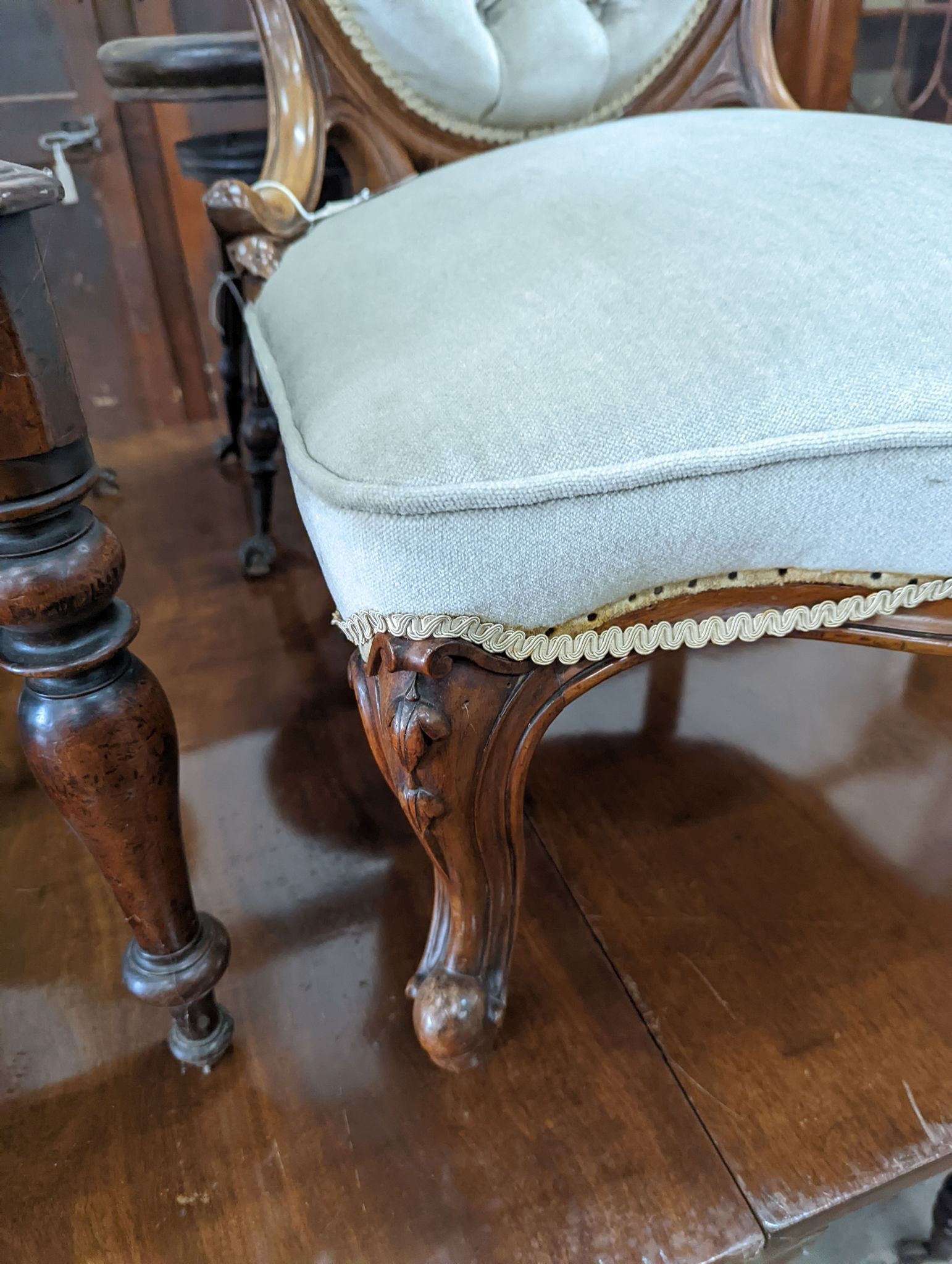 A Victorian walnut upholstered spoonback nursing chair